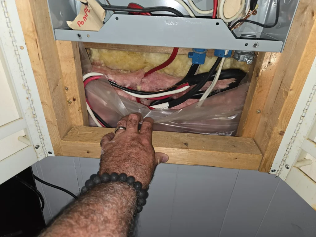 Home inspector examining accessible electrical wiring and panel components