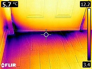 Thermal imaging showing a cooler surface pattern near an exterior door